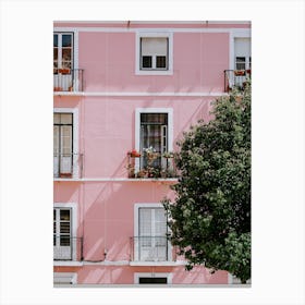 A perfect pink building with flowers on a balcony in Lisbon Canvas Print