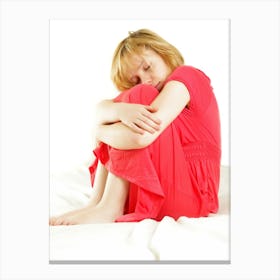 Sad Young Girl Sitting On A Bed Canvas Print