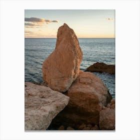 Rocks and the sea at sunset Canvas Print