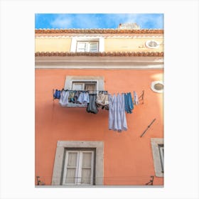 Laundry on a line in Alfama, Lisbon, Portugal with an orange stucco wall. Summer nature and travel photography by Christa Stroo Canvas Print