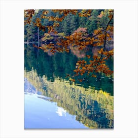 Autumn Leaves Reflected In A Lake Canvas Print
