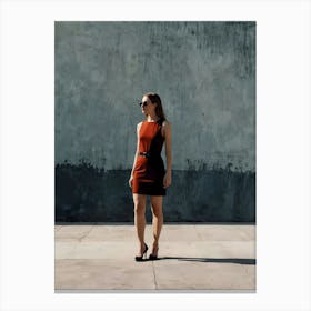 Woman In Red Dress Standing In Front Of Concrete Wall Canvas Print