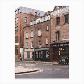 London, England I Street with brick architecture facades in Londoner vintage district of Spitafields from a retro UK urban landscape to the dark moody aesthetic of an analog film photography Canvas Print