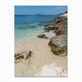 Clear sea water and rocks in a bay Canvas Print