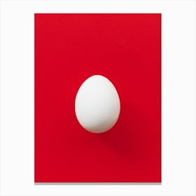 White Egg On Red Background Canvas Print