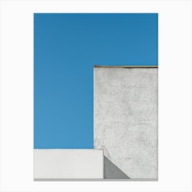 White Building Against A Blue Sky Canvas Print