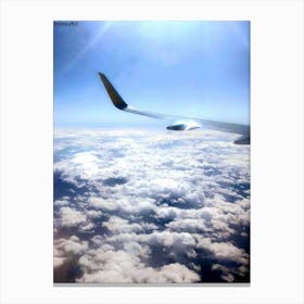 Airplane Wing Above Clouds Canvas Print