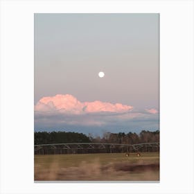 Moon in the sunset clouds Canvas Print