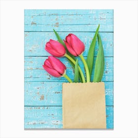 Tulips In A Paper Bag On A Wooden Background Canvas Print