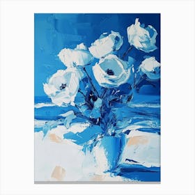 White Flowers In A Blue Vase Canvas Print