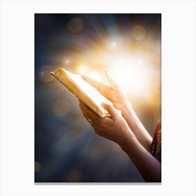 A Hand Gently Holding Open A Holy Bible To Highlight A Passage Surrounded By A Soft Glow That Sugge (5) Canvas Print