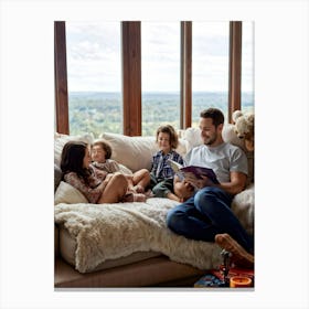 Family Engrossed In A Book Lounged Together On A Plush Sofa In A Warm Ambient Light Filled Living Canvas Print