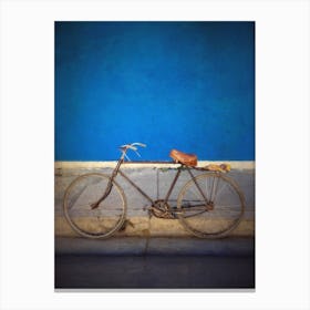Old Bicycle Against Blue Wall Canvas Print