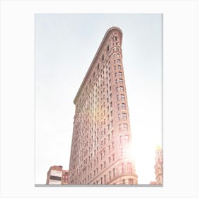 New York, USA I The Flatiron building in the sun with original and flat architecture between Broadway and 5th Avenue in a retro vintage postcard photography aesthetic atmosphere for a mythical NYC landmark Canvas Print