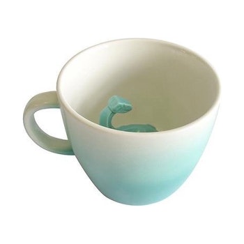 Dinosaur Surprise Turquoise Mug by House of disaster